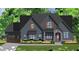 Rendering of a charming craftsman home with gray siding, stone accents, and a beautifully landscaped front yard at 30 Cherry Bark Dr, Youngsville, NC 27596