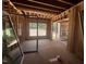 Unfinished living room boasts exposed beams and framing for large windows, bathing the space in natural light at 30 Cherry Bark Dr, Youngsville, NC 27596