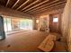 Unfinished living room showcases exposed beams, natural light, and views of the surrounding wooded landscape at 30 Cherry Bark Dr, Youngsville, NC 27596
