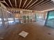 Unfinished living room showcases exposed beams and large windows overlooking the wooded landscape at 30 Cherry Bark Dr, Youngsville, NC 27596