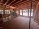 Unfinished living room with natural light streaming in from the numerous windows overlooking the wooded landscape at 30 Cherry Bark Dr, Youngsville, NC 27596