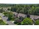 Stunning aerial view of a brick home nestled among mature trees in a desirable residential neighborhood at 308 Sutton Glen Dr, Apex, NC 27523