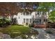 Backyard view of large home with a spacious lawn, patio, and mature trees, perfect for outdoor living at 308 Sutton Glen Dr, Apex, NC 27523