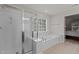 Bright bathroom features a glass-enclosed shower, garden tub, and neutral tile flooring at 308 Sutton Glen Dr, Apex, NC 27523