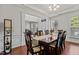 Elegant dining room with hardwood floors, stylish chairs, and ample seating for entertaining guests at 308 Sutton Glen Dr, Apex, NC 27523