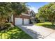 Brick home with an attached two-car garage, a well-kept lawn, and mature shade trees at 308 Sutton Glen Dr, Apex, NC 27523