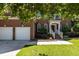 Classic brick home with a two-car garage, beautiful landscaping, and inviting front entrance at 308 Sutton Glen Dr, Apex, NC 27523