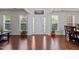 Elegant foyer featuring gleaming hardwood floors, a bright entryway, and decorative columns at 308 Sutton Glen Dr, Apex, NC 27523