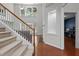 Spacious foyer with staircase, large windows, and a view of the living room at 308 Sutton Glen Dr, Apex, NC 27523