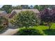 Charming brick home showcasing a mature flowering tree in the front yard and a well-manicured lawn at 308 Sutton Glen Dr, Apex, NC 27523