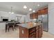 Kitchen with island and breakfast bar open to the adjacent living area with a fireplace at 308 Sutton Glen Dr, Apex, NC 27523