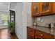 Close up of the kitchen counter and cabinets, showing granite countertops and tiled backsplash at 308 Sutton Glen Dr, Apex, NC 27523