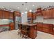 Well-equipped kitchen featuring custom cabinets, stainless steel appliances, and a center island at 308 Sutton Glen Dr, Apex, NC 27523