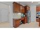 View of kitchen with adjacent home office area featuring custom cabinets and stainless appliances at 308 Sutton Glen Dr, Apex, NC 27523