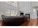 Elegant living room featuring a fireplace, a high ceiling and large bright windows at 308 Sutton Glen Dr, Apex, NC 27523
