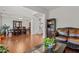 Spacious living room showcasing hardwood floors, a staircase, and seamless transition to the dining area at 308 Sutton Glen Dr, Apex, NC 27523