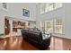 Open-concept living room featuring a high ceiling, large windows, and hardwood flooring at 308 Sutton Glen Dr, Apex, NC 27523