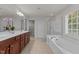 Bright main bathroom featuring double vanity, soaking tub, and walk-in closet at 308 Sutton Glen Dr, Apex, NC 27523