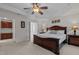 Large main bedroom suite with tray ceiling, ceiling fan, and an adjoining bathroom at 308 Sutton Glen Dr, Apex, NC 27523
