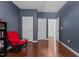 Spacious office with hardwood floors, red chair and multiple doors at 308 Sutton Glen Dr, Apex, NC 27523