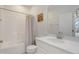 Bright bathroom with a shower-tub, white vanity with granite countertops, and a decorative painting at 3636 Water Mist Ln, Raleigh, NC 27604