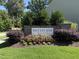Attractive stone community sign surrounded by colorful flowers and well-maintained landscaping at 3636 Water Mist Ln, Raleigh, NC 27604