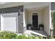 Close-up of front entryway with stone detail, one car garage, and lovely front door with welcoming mat at 3636 Water Mist Ln, Raleigh, NC 27604