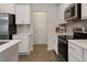 Well-lit kitchen with stainless steel appliances, sleek countertops, and stylish backsplash at 3636 Water Mist Ln, Raleigh, NC 27604