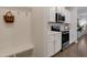 Modern kitchen with stainless steel appliances, white cabinets, and nearby hall tree at 3636 Water Mist Ln, Raleigh, NC 27604
