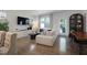 Bright living room featuring modern decor, hardwood floors, and large windows with lots of natural light at 3636 Water Mist Ln, Raleigh, NC 27604