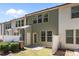 View of back of townhome with fenced-in patio, green siding, and plenty of windows at 3810 Prince Noah Loop, Wake Forest, NC 27587