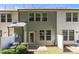 View of back of townhome featuring an enclosed patio, multiple windows, and green siding at 3810 Prince Noah Loop, Wake Forest, NC 27587