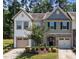Charming two-story townhome with stone accents, attached garages, and a well-maintained lawn at 3810 Prince Noah Loop, Wake Forest, NC 27587