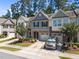 Street view of charming townhomes with well manicured landscaping and single car garages at 3810 Prince Noah Loop, Wake Forest, NC 27587
