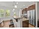 Stylish kitchen with granite countertops, stainless steel appliances, and a breakfast bar at 3810 Prince Noah Loop, Wake Forest, NC 27587