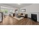 Open-concept living room with wood floors, a fireplace, and views of the kitchen at 3810 Prince Noah Loop, Wake Forest, NC 27587