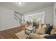 Inviting living room with a staircase, an open-concept layout and wood floors at 3810 Prince Noah Loop, Wake Forest, NC 27587