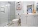Bathroom featuring a frameless glass walk-in shower, white vanity, and stylish mirror at 4203 Overcup Oak Ln, Cary, NC 27519