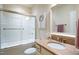 Bathroom featuring a tub/shower combo with sliding glass doors and a vanity with a sink at 4203 Overcup Oak Ln, Cary, NC 27519