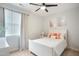 Bedroom featuring white furniture, neutral walls, ceiling fan, and a window with curtains at 4203 Overcup Oak Ln, Cary, NC 27519