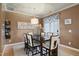 Dining room with elegant table set, chandelier, and door to the backyard at 4203 Overcup Oak Ln, Cary, NC 27519
