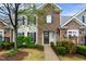 Beautiful townhome with stone accents and a well-maintained front yard with lush greenery at 4203 Overcup Oak Ln, Cary, NC 27519