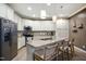 Well-lit kitchen featuring granite countertops, stainless steel appliances, and a center island with seating at 4203 Overcup Oak Ln, Cary, NC 27519