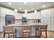 Well-lit kitchen featuring granite countertops, stainless steel appliances, and a center island with seating at 4203 Overcup Oak Ln, Cary, NC 27519