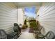 Inviting covered patio with wicker furniture and a grill, perfect for outdoor relaxation and entertaining at 4203 Overcup Oak Ln, Cary, NC 27519