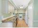 Functional kitchen featuring light-colored cabinetry, modern appliances, and durable tile countertops at 4305 Lake Ridge Dr, Raleigh, NC 27604