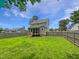 Spacious fenced-in backyard with lush green grass and a screened back porch at 5356 Baywood Forest Dr, Knightdale, NC 27545