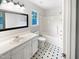 Neat bathroom with updated vanity, black and white tile floors, and a shower-tub combination at 5356 Baywood Forest Dr, Knightdale, NC 27545