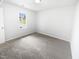 Clean bedroom featuring neutral carpet, paint and a window with a view to the neighborhood at 5356 Baywood Forest Dr, Knightdale, NC 27545