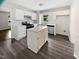 Well-lit kitchen with white cabinets, stainless steel appliances, and a center island at 5356 Baywood Forest Dr, Knightdale, NC 27545